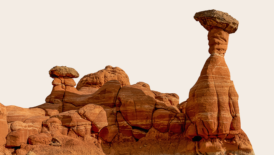 A mountainous view of a few pillars in the desert