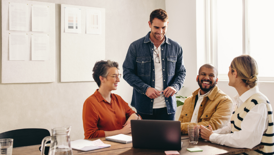 A photo of a team meeting in a small conference room