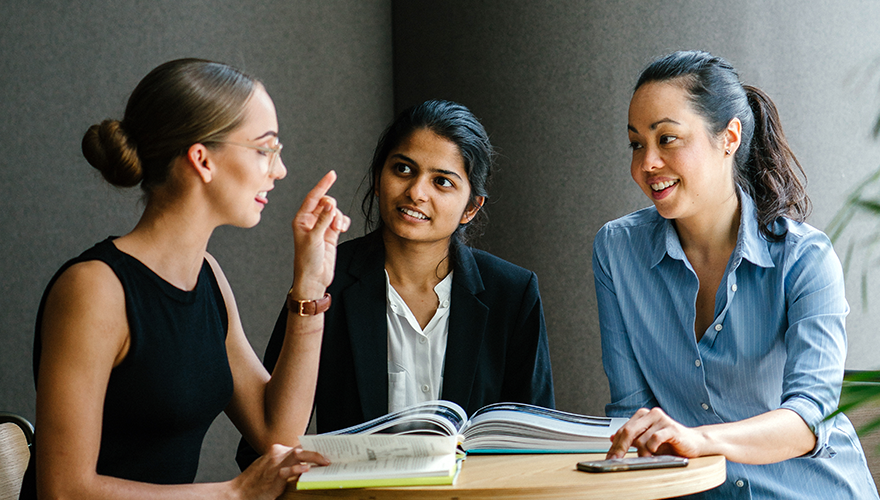 A team of women sitting in a meeting