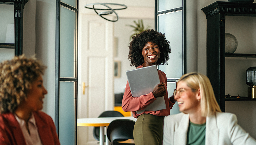 A photo of a woman walking into a conference room