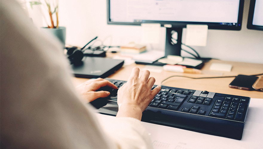 Photo of someone's hands on a keyboard