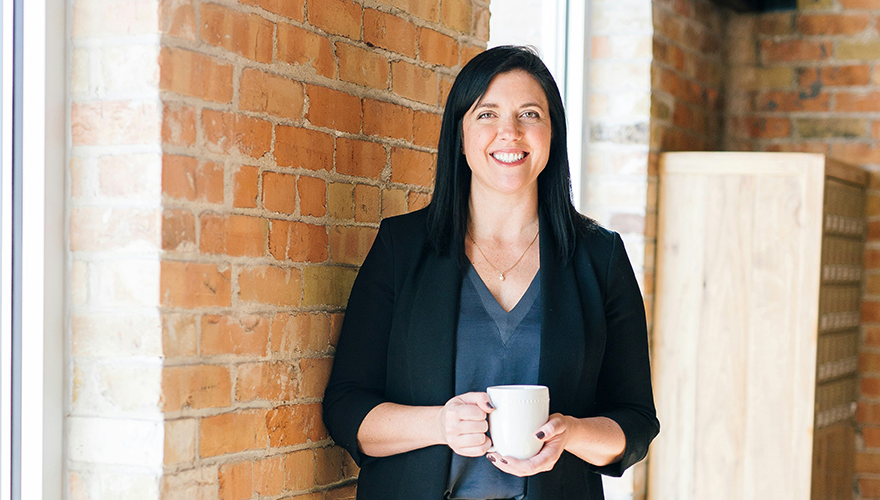 A photo of a businesswoman smiling at the camera