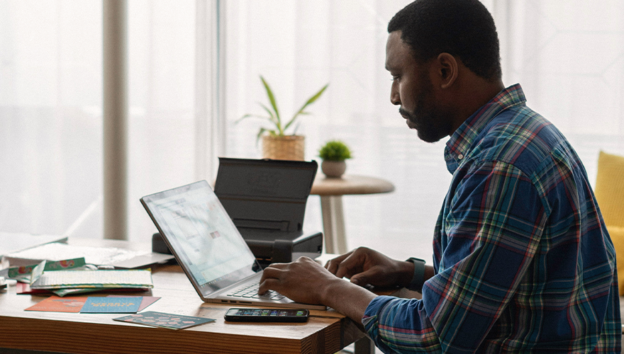 A photo of a man working at a desk